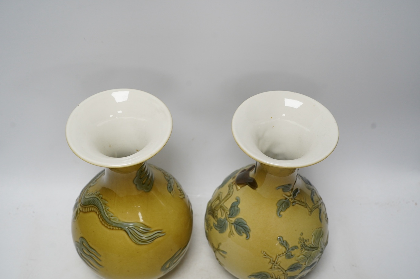 Two Lladro vases decorated in relief with dragons and birds, 26cm high. Condition - good